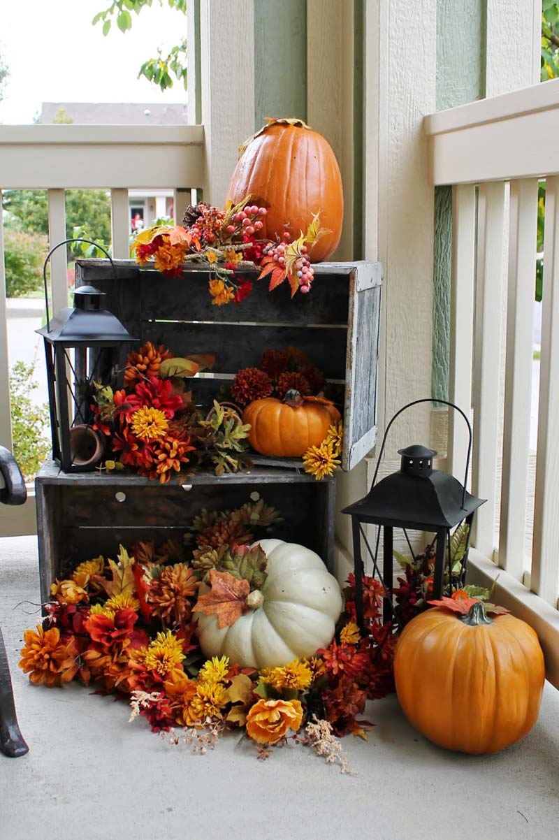 small front porch decorating ideas - traditional fall decor with colorful pumpkins, flowers, fall bushes, and over-sized lanterns #frontporchideas #outdoorfalldecoratingideas #smallfrontporchdecoratingideas